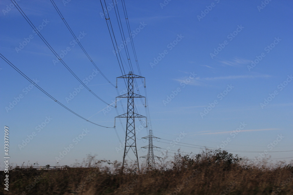 Electricity pylon (Strommasten) also overhead line pylon. carring electric energy though lines via pylon across countryside Electricity pylon (Strommasten) also overhead line pylon. carring electric energy though lines via pylon across countryside