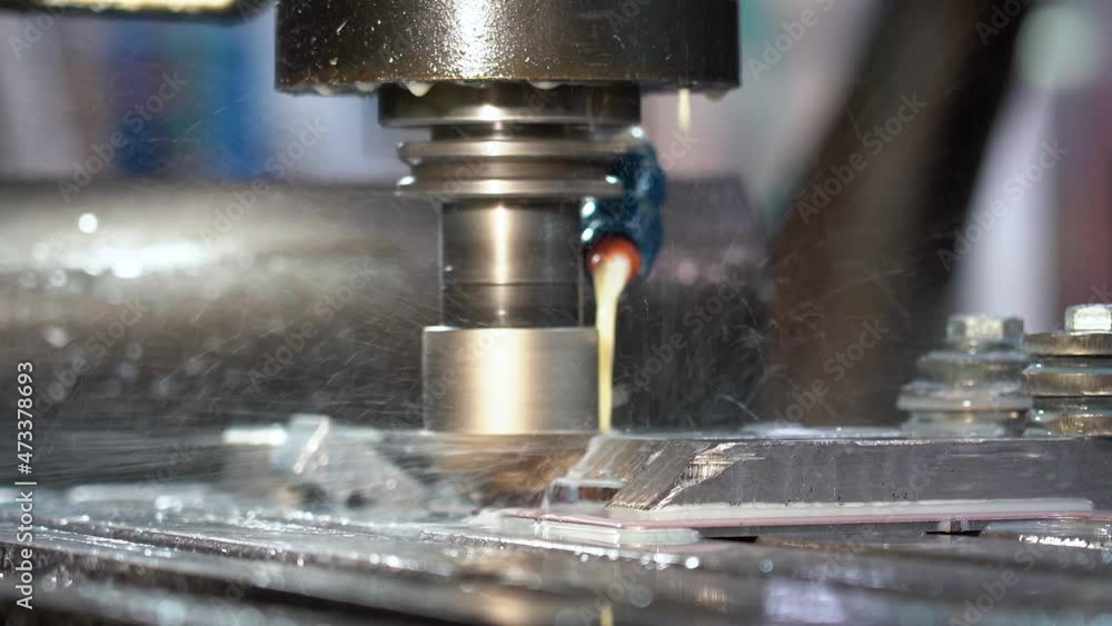 CNC Milling Machine Tool Cutting Steel - Zoom Out Shot. Closeup Shot of a CNC Machine Processing A Piece Of Metal. Milling Tool Cooling By Coolant Emulsion. CNC Milling Machine Tool Cutting Steel - Zoom Out Shot. Closeup Shot of a CNC Machine Processing A Piece Of Metal. Milling Tool Cooling By Coolant Emulsion.