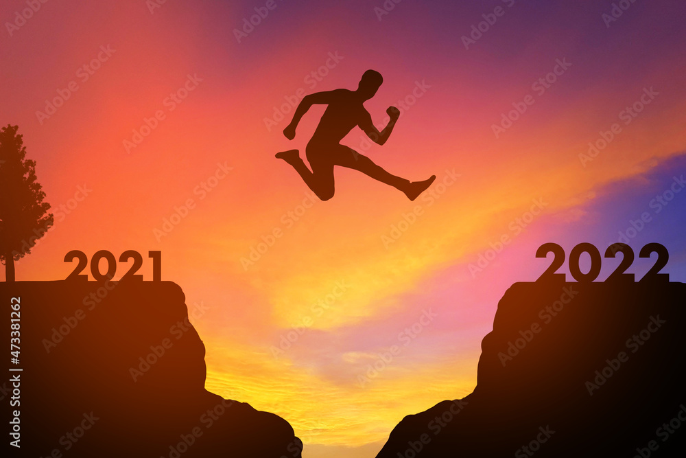 man jumping from 2021 to 2022- New year business concept