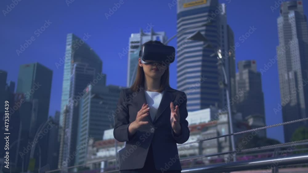Future is now. Woman using virtual reality device while traveling in Singapore . Future is now. Woman using virtual reality device while traveling in Singapore .
