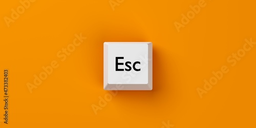 Fotografie Single, white computer keyboard escape key over orange background, stop, quit or