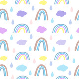 Seamless pattern with rainbows and clouds in Scandinavian style. Boho pattern for the nursery.Hand drawn rainbow vector.