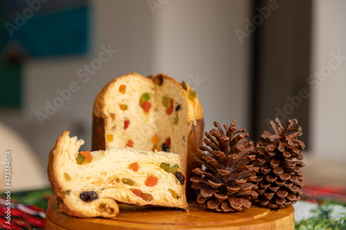 Принти на полотні Panettone cut with candied fruit on the Christmas dinner table, approximate phot