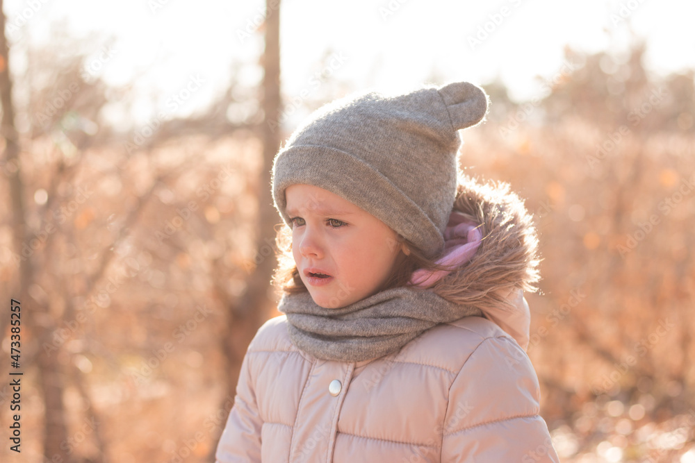 Little girl in a hat and a scarf for a walk in the autumn park. Little girl in a hat and a scarf for a walk in the autumn park.
