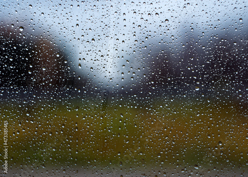 Small drops formed on the window pane. Water droplets are photographed in close-up.