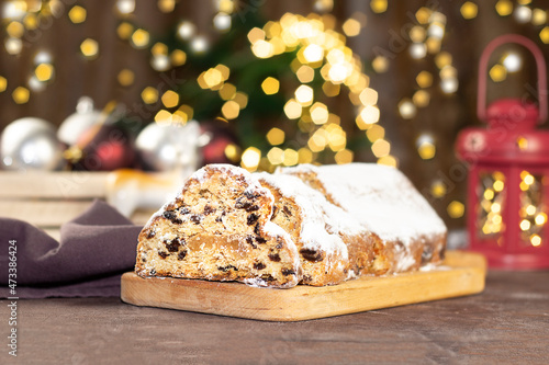 Christmas stollen on wooden background. Christmas Stollen cake and bokhe. Traditional hand made german christmas stollen