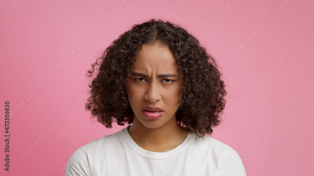 Angry African American Woman Frowning Expressing Negative Emotions, Pink Background Angry African American Woman Frowning Expressing Negative Emotions, Pink Background