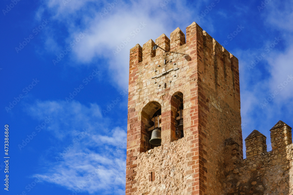 Old clock tower against blue sky in Molina de Aragon castle, Guadalajara Spain