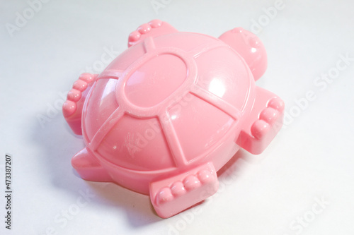 Toy pink turtle made of plastic