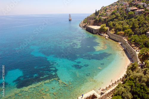 Alanya, Turkey - 2 July 2015: view from above to the Mediterranean Sea, picturesque bottom, the fortress walls, the ship in the distance and Tersane Beach on a bright sunny day