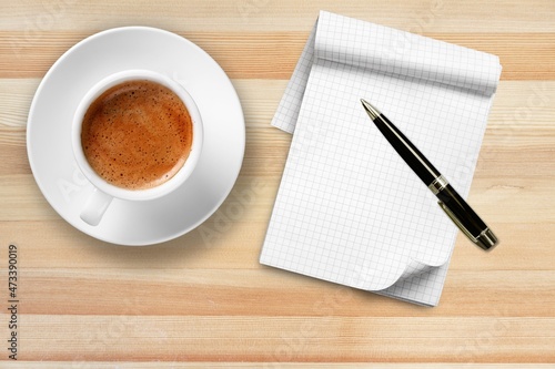 Paper with a cup of coffee, product or business review of the recent year