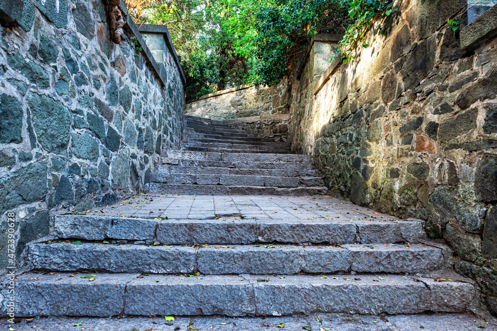 A narrow street with stone steps and walls A narrow street with stone steps and walls