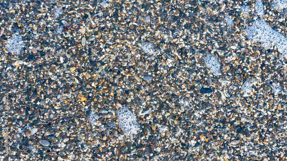 sea beach of small multi-colored pebbles as a natural background sea beach of small multi-colored pebbles as a natural background