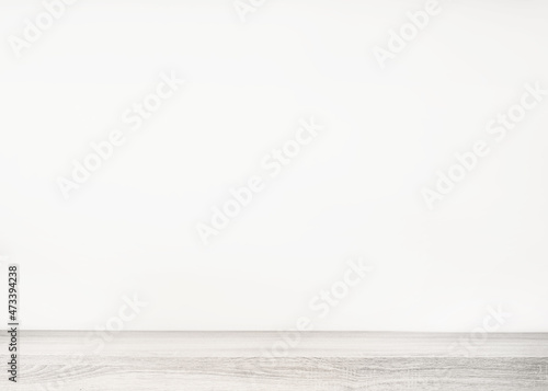 Empty white wood table top and blur wall. Wall Texture Background. Building banner mock up abstract background - can used for display or montage your products.