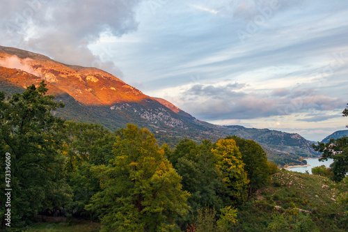 House in the woods in Abruzzo in autumn. Foliage and colors of trees.