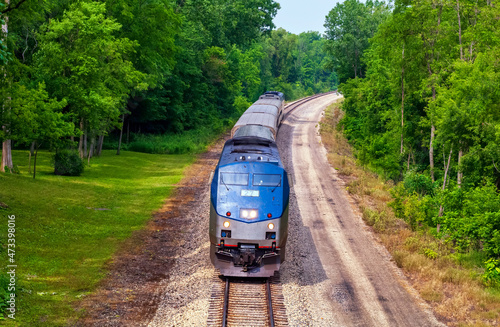 Fotografie, Tablou Amtrak passenger train traveling from Chicago, Illinois to Detroit, Michigan thr