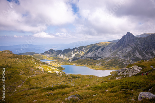 Beautiful landscape of the Seven Rila Lakes Bulgaria. Amazing nature shot  mountains and lake.Reflecting water on sunny cloudy day. High quality photo