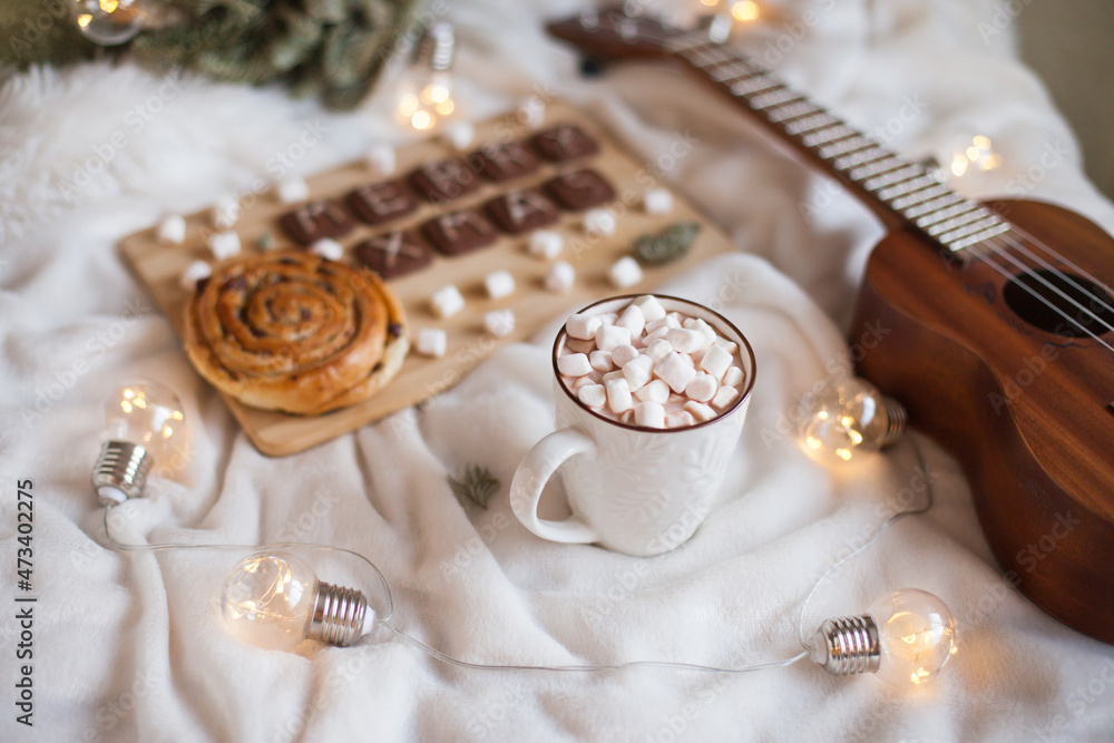 A cup of hot cocoa with marshmallows with christmas decor, pastry and cookies. Cozy ambience at home for christmas. Merry Christmas cookies
