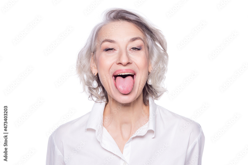 Shot of a beautiful mature woman having fun and teasing sticking out her tongue isolated on white background Shot of a beautiful mature woman having fun and teasing sticking out her tongue isolated on white background