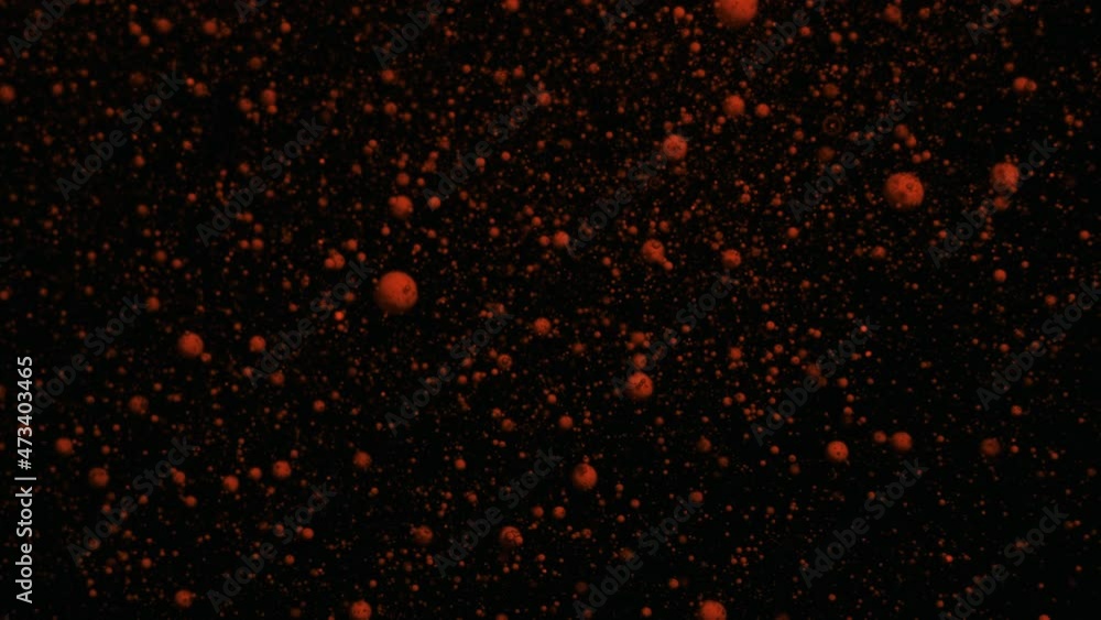 Orange volumetric fluorescent particles move and change on a black moving background, transition. Orange volumetric fluorescent particles move and change on a black moving background, transition.