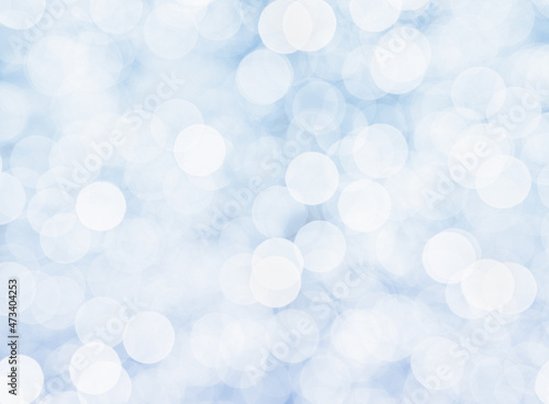 Blurry bokeh background in white and blue with a winter feeling.