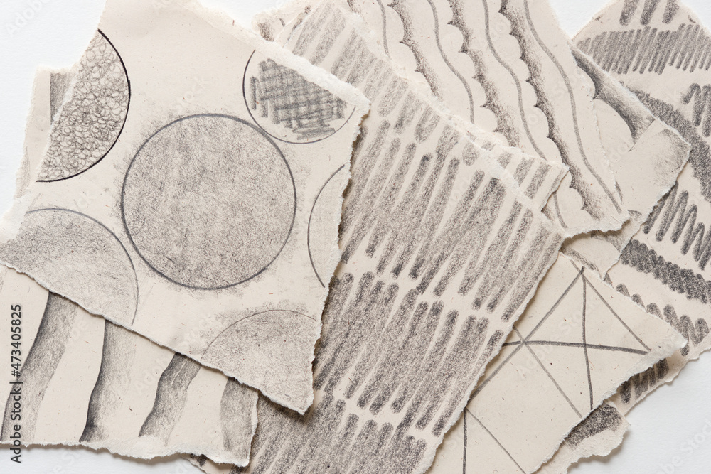 torn paper background with graphite patterns torn paper background with graphite patterns