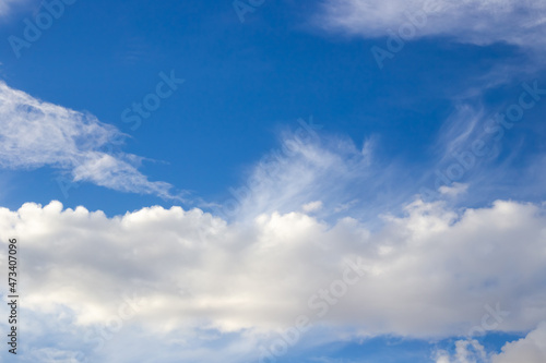 White fluffy clouds against a blue sky. Air background, place for text