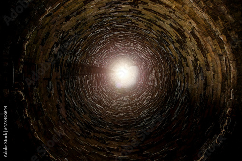 Inside old brick tube shaft with ladder