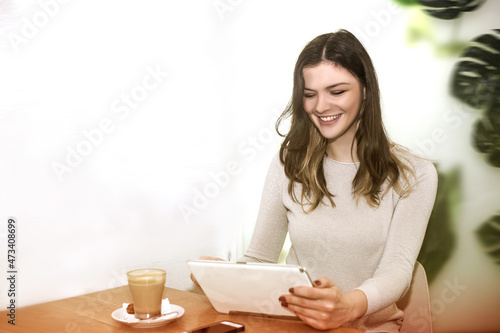 young woman works from cafe 