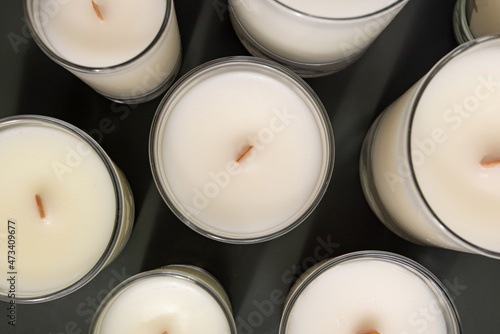 Handmade soy candle in glass cup with wooden wick. Natural. Scented candle for interior photo