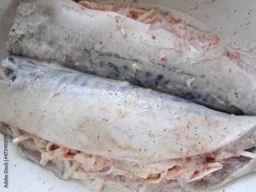 fish stuffed with vegetables and sauce prepared for baking