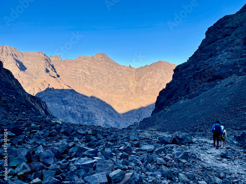 Hikers descending from Djebel Toubkal, North Africa's highest mountain, at dawn. Morocco.