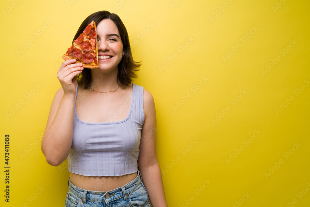 Cheerful woman having fun while eating pizza Cheerful woman having fun while eating pizza