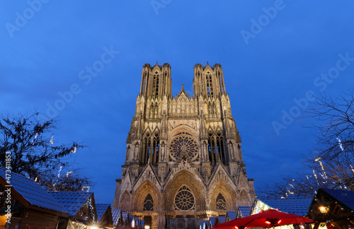 Cathedral of Notre Dame, Reims and Christmas market stalls in the night. One of the most stunning masterpieces of 13th century Gothic art. photo