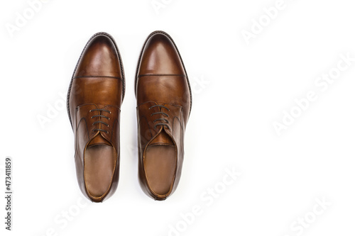 Zapatos de hombre de piel marrón con cordones sobre un fondo blanco liso y aislado. Vista superior. Copy space