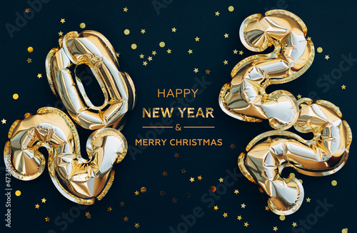 Happy New Year 2022 greeting card. golden foil balloons numbers and confetti. Top horizontal view copy space new year and christmas holiday concept.