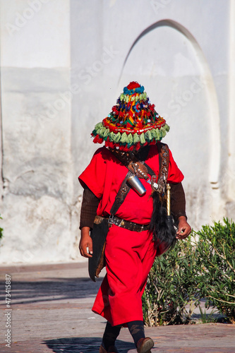 Traditional water seller in red uniform in the Djemma el Fna, Marrakech, Morocco