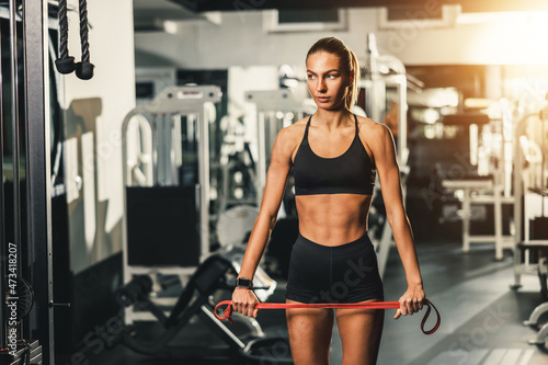 Woman Doing Exercise With Resistance Band At The Gym