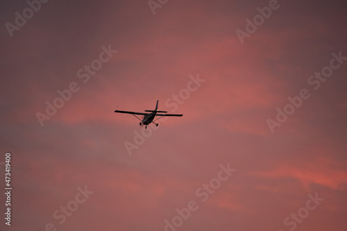 Private airplane takes of from airport into the sunset
