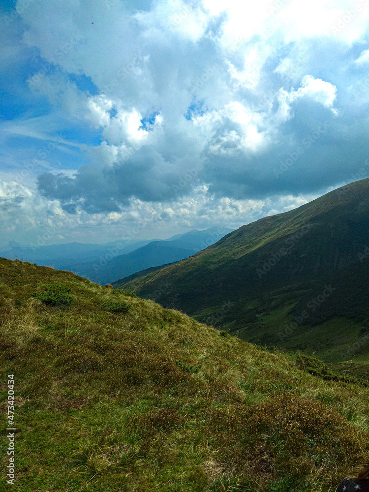 Scenic view of mountains against blue sky