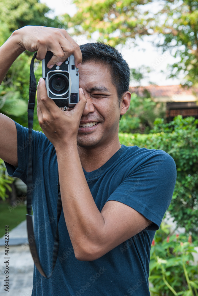 man taking photo with analog range finder camera