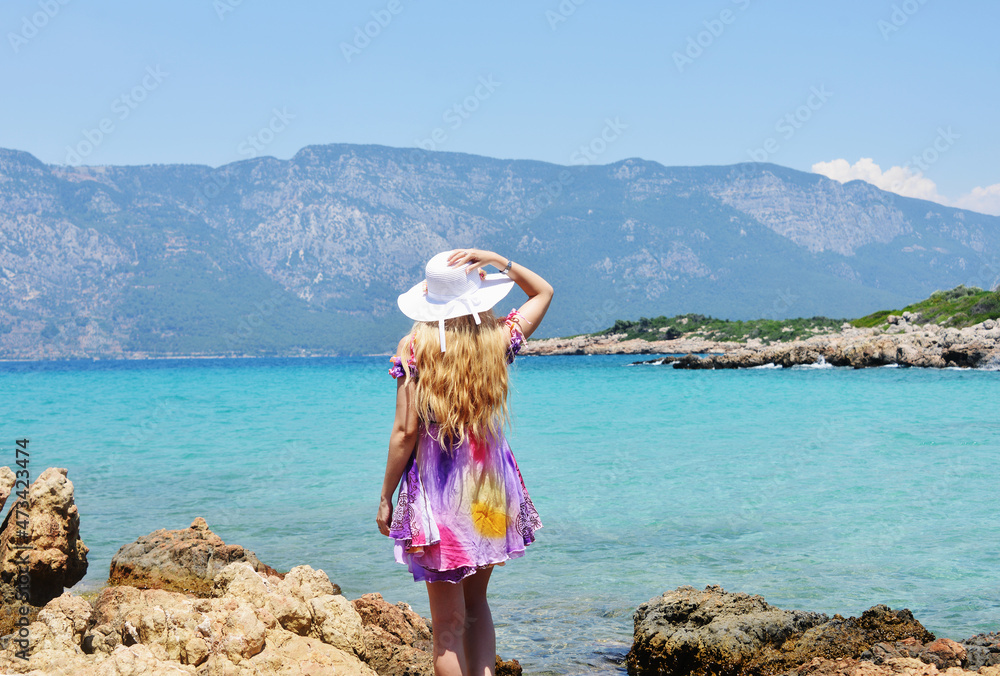 Back view of blond woman on Cleopatra Island in Turkey