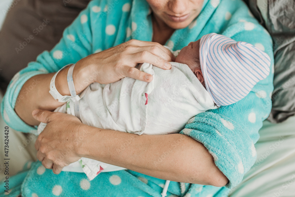 Close up image of mother holding newborn son right after birth Close up image of mother holding newborn son right after birth