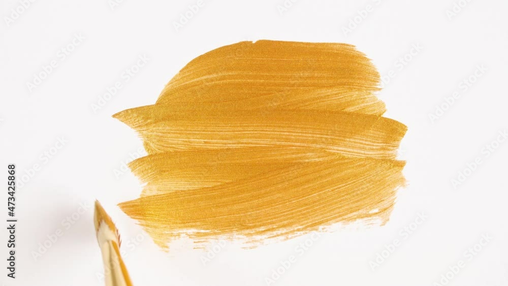 Abstract brushstrokes of gold paint brush applied isolated on a white background. Gold paint smear texture. Golden sparkling textured artistic illustration. Smears of cosmetics. High quality 4k Abstract brushstrokes of gold paint brush applied isolated on a white background. Gold paint smear texture. Golden sparkling textured artistic illustration. Smears of cosmetics. High quality 4k