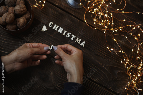 Woman putting Christmas letters onto the table photo