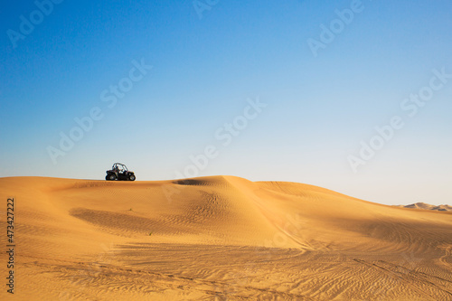 View of riding buggy quad bike in desert dune Al Awir near Dubai