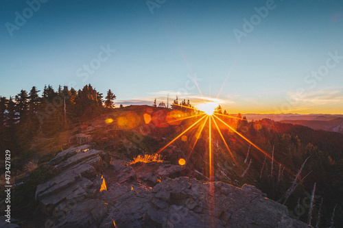 The sun is rising up above mt. Rainier National Park