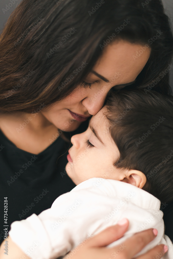 Mother hold sleeping son, both with eyes closed. Mother hold sleeping son, both with eyes closed.