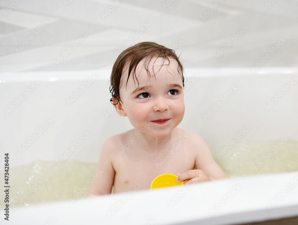 Adorable toddler having fun during evening bath time Adorable toddler having fun during evening bath time