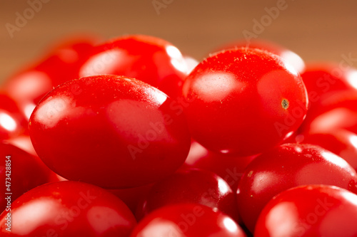 Fresh grape tomatoes in a bowl on the table. © WS Studio